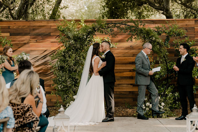 bride and groom kissing after they say I do!