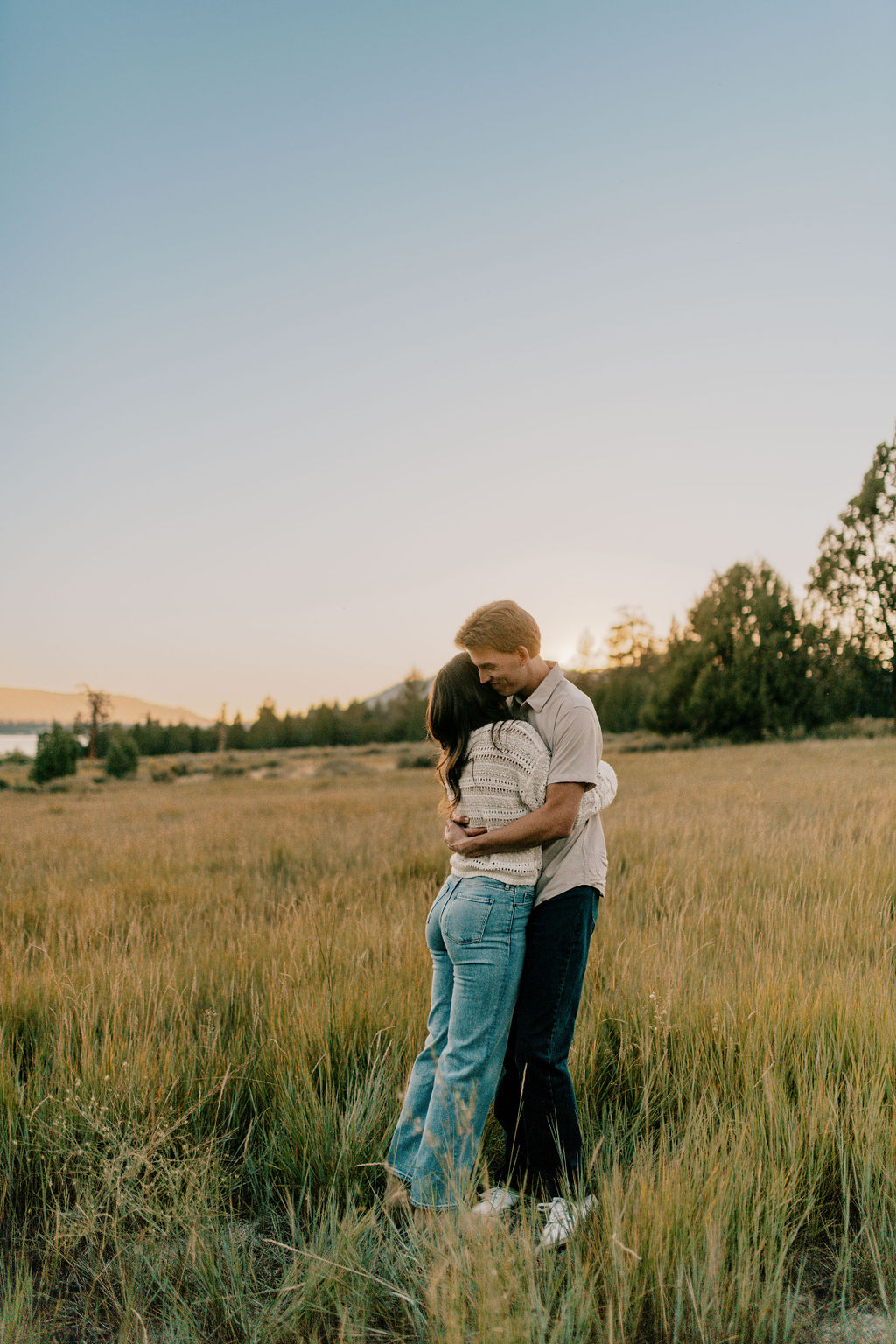 a couple hugging as the sun is going down at big bear lake